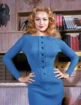 Julie Newmar in blue sweater dress