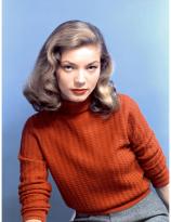 Lauren Bacall  in an orange turtleneck, circa the 40s