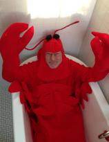 Patrick Stewart in a bathtub dressed like a lobster