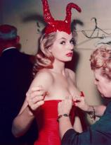 Anita Ekberg being fitted into a devil costume, Hotel Commodore, 1955