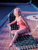 Marilyn Monroe sitting by the pool photographed by Harold Lloyd, 1953