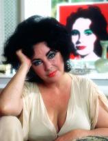 Elizabeth Taylor in front of her portrait by Andy Warhol