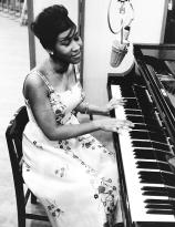 Aretha Franklin sings and plays the piano during a recording session for Columbia Records, New York, 1960