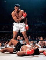 Muhammad Ali stands over Sonny Liston and yells at him after knocking the former champ down in the first round of their 1965 rematch
